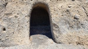 Burrow carved in volcanic cliff